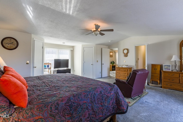 carpeted bedroom featuring ceiling fan, a textured ceiling, and lofted ceiling