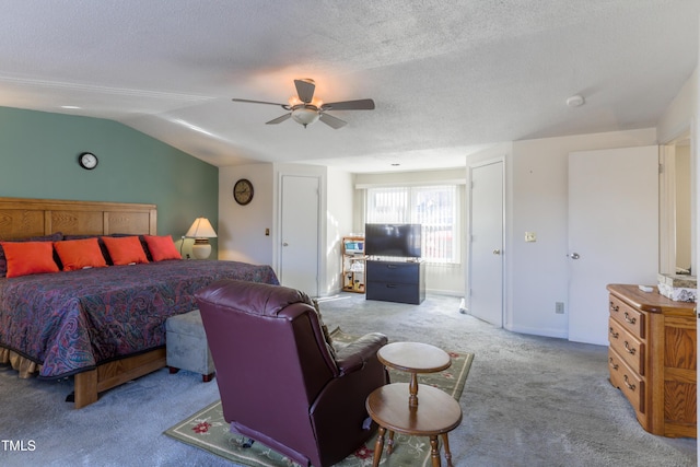 carpeted bedroom with ceiling fan, a textured ceiling, and vaulted ceiling