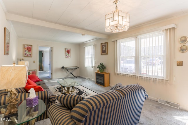 carpeted living room with a notable chandelier and beamed ceiling