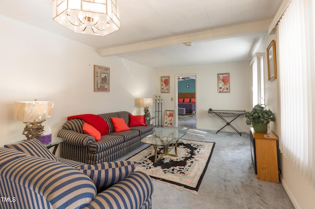 carpeted living room featuring ceiling fan with notable chandelier and beamed ceiling