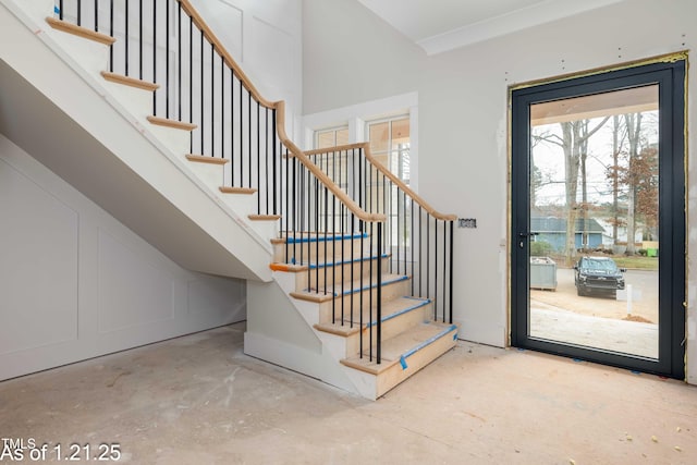 entryway featuring concrete floors and stairway