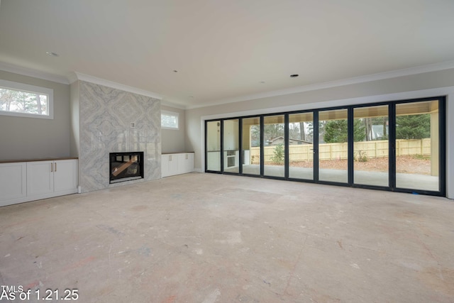 unfurnished living room featuring ornamental molding and a high end fireplace