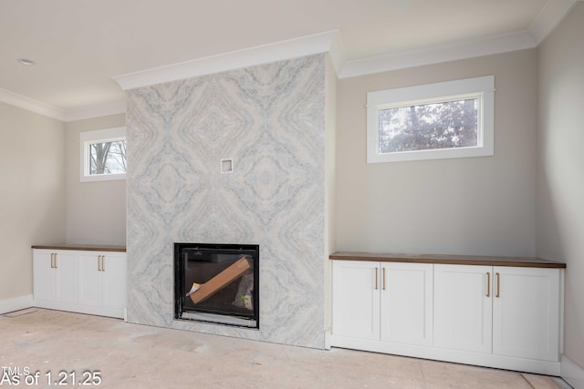 living room featuring crown molding, a fireplace, and baseboards