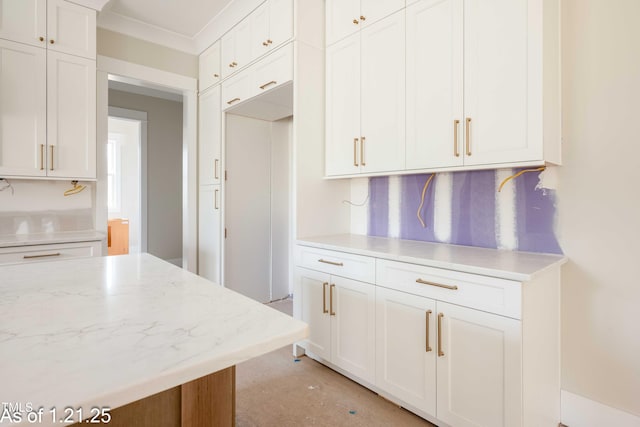 kitchen with light stone counters and white cabinets