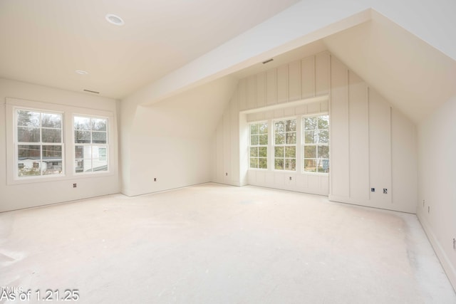 bonus room with lofted ceiling and visible vents