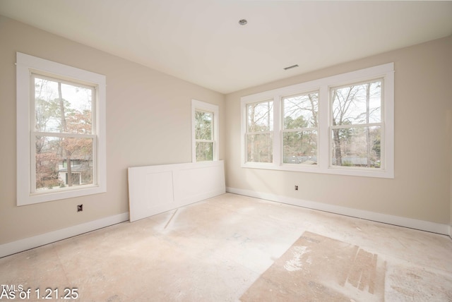 spare room with baseboards and visible vents