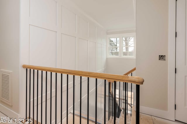 stairway featuring visible vents and baseboards