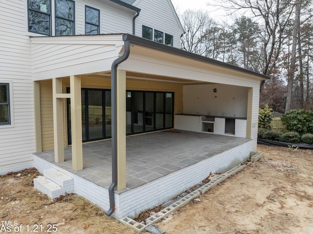 back of property with a patio