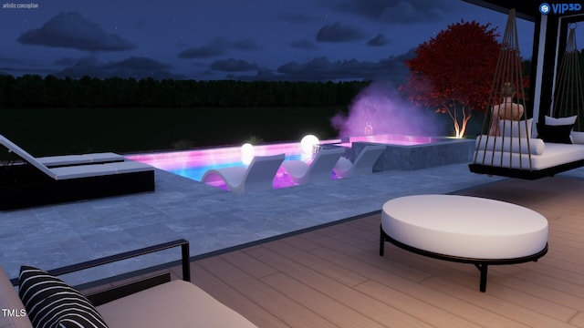 pool at night with an outdoor pool