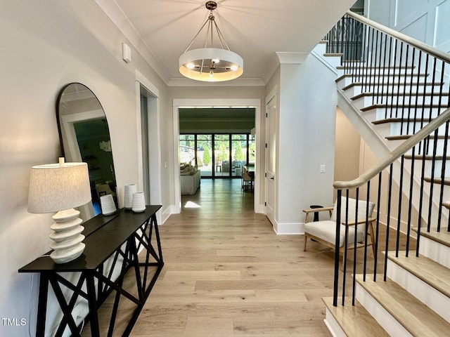 4005 Brevard Pl, Raleigh, NC 27609 - corridor with light wood finished floors, ornamental molding, stairs, and baseboards