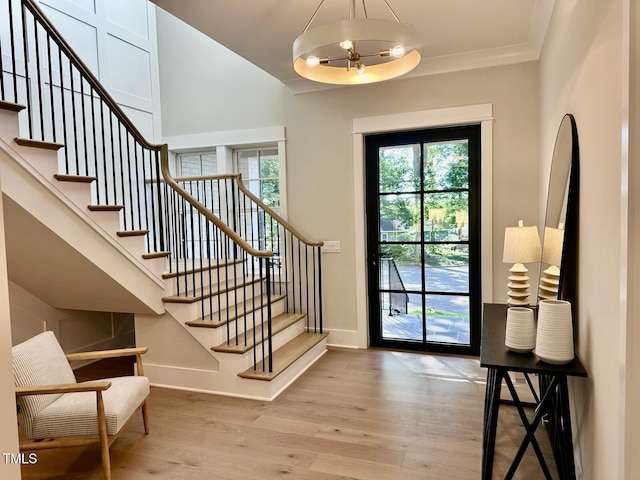 4005 Brevard Pl, Raleigh, NC 27609 - entrance foyer featuring wood finished floors, stairway, baseboards, and ornamental molding