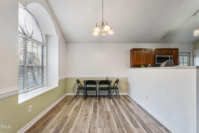 dining area with a chandelier and light wood-type flooring