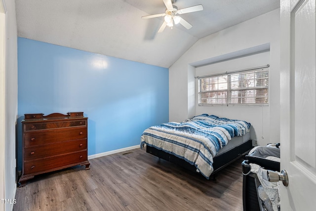 bedroom featuring ceiling fan, hardwood / wood-style floors, and lofted ceiling