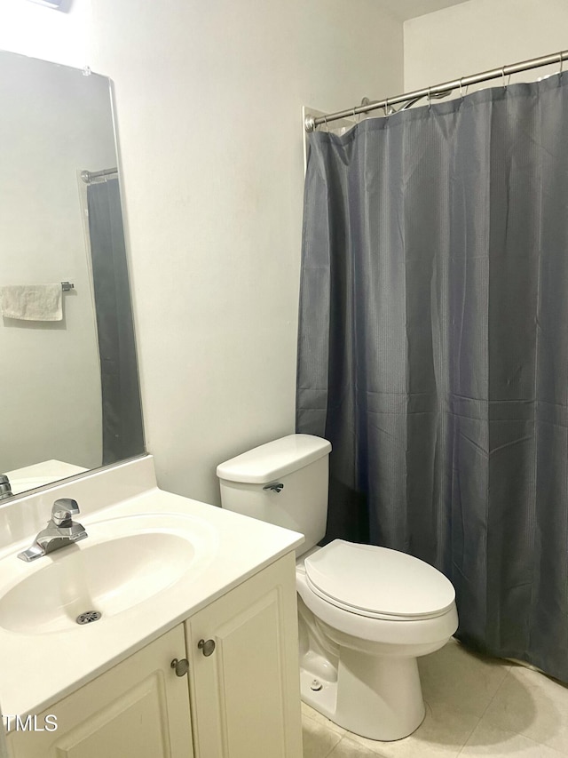 bathroom featuring a shower with curtain, vanity, toilet, and tile patterned flooring