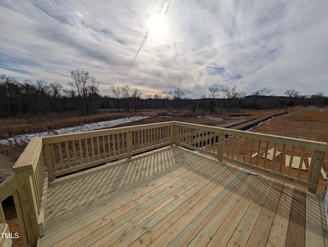 wooden terrace featuring a rural view