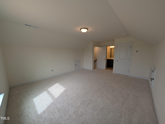 19 Grassland Dr, Garner, NC 27529 - additional living space featuring light carpet, baseboards, vaulted ceiling, and visible vents