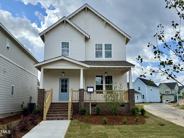 view of front facade with central AC, covered porch, and concrete driveway