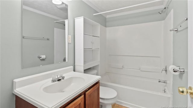 bathroom featuring bathtub / shower combination, toilet, ornamental molding, vanity, and a textured ceiling