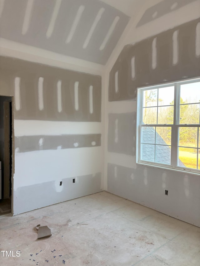 empty room with lofted ceiling