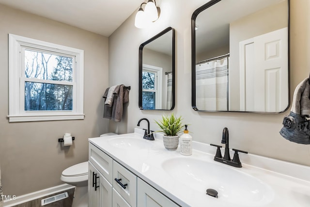 bathroom featuring toilet and vanity