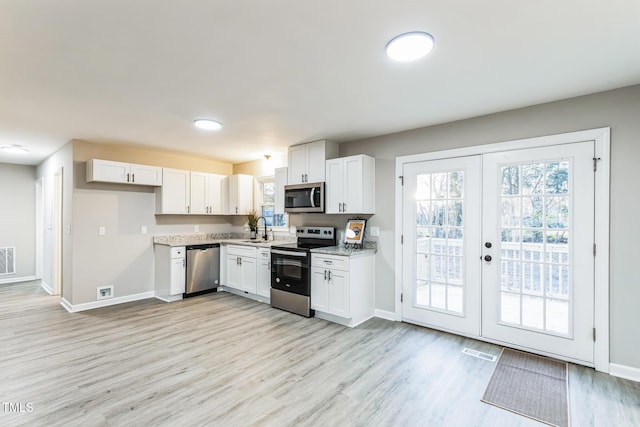 kitchen featuring white cabinets, appliances with stainless steel finishes, sink, and french doors