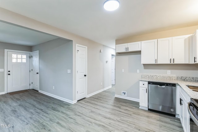 kitchen featuring stainless steel dishwasher, white cabinets, electric stove, and light hardwood / wood-style floors