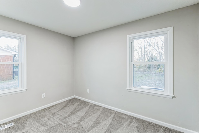 carpeted empty room featuring a healthy amount of sunlight