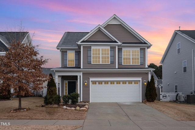 front of property featuring a garage and central air condition unit