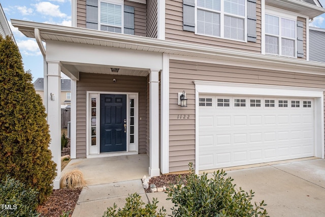 doorway to property with a garage