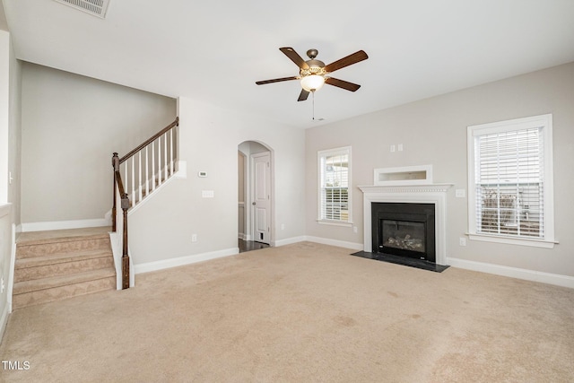 unfurnished living room with light carpet and ceiling fan