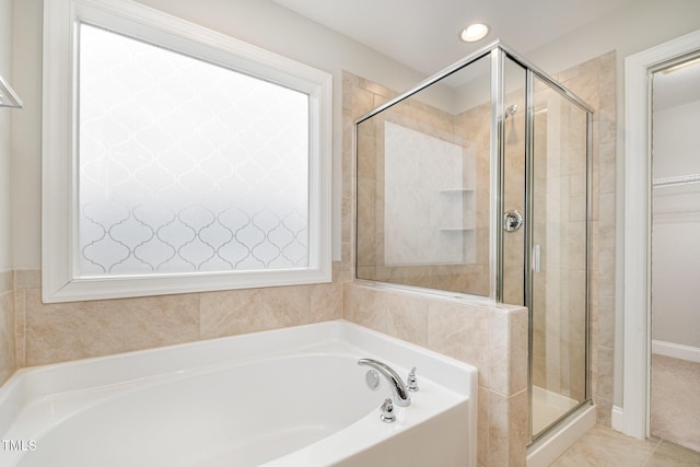 bathroom featuring tile patterned floors and independent shower and bath