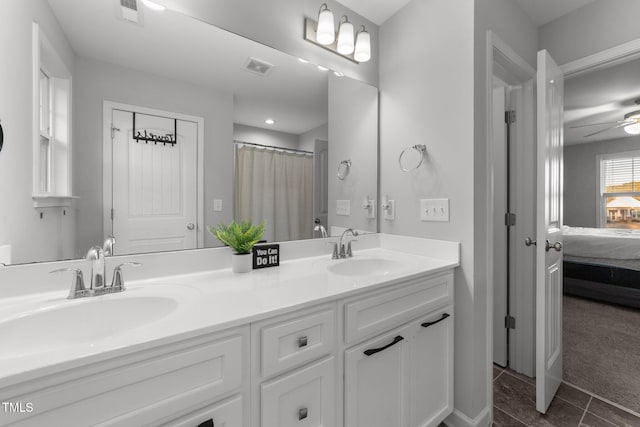 bathroom with ceiling fan, vanity, and tile patterned flooring