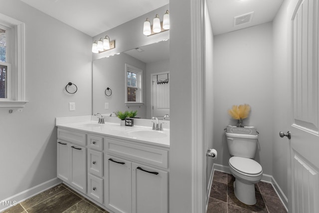 bathroom featuring toilet and vanity