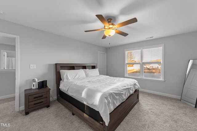 bedroom with ceiling fan and light colored carpet