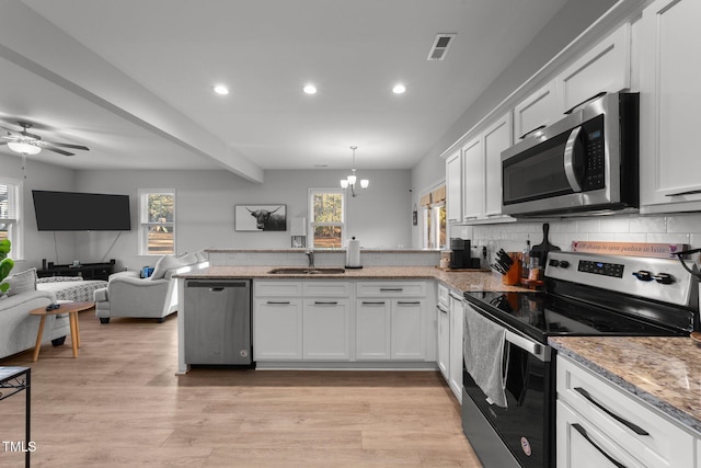 kitchen featuring white cabinets, appliances with stainless steel finishes, and sink