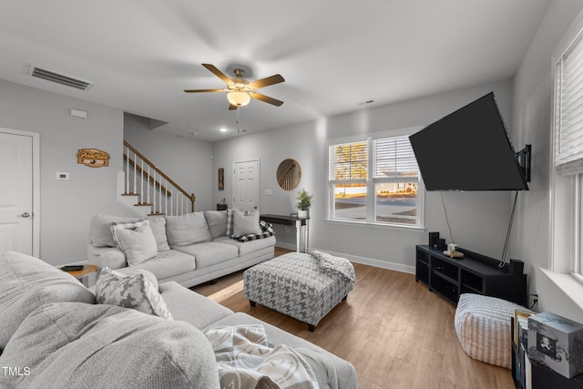 living room featuring ceiling fan and hardwood / wood-style flooring