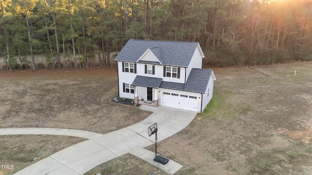 view of front of property featuring a front lawn and a garage