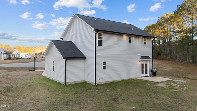 back of property featuring a patio area and a yard