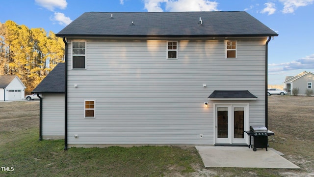 rear view of property with a lawn and a patio