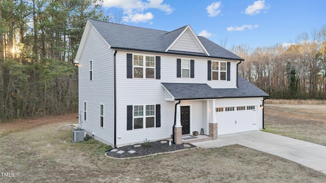 view of front facade with a garage, a front lawn, and central air condition unit