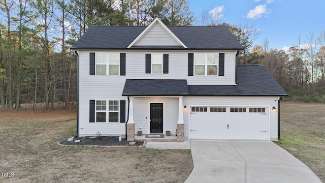 view of front of property featuring a front lawn and a garage