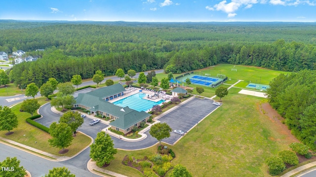 birds eye view of property with a forest view