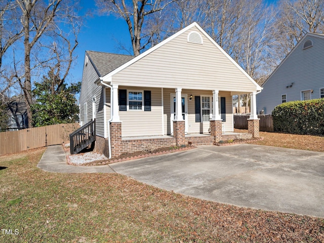 view of front of home with covered porch and a front yard