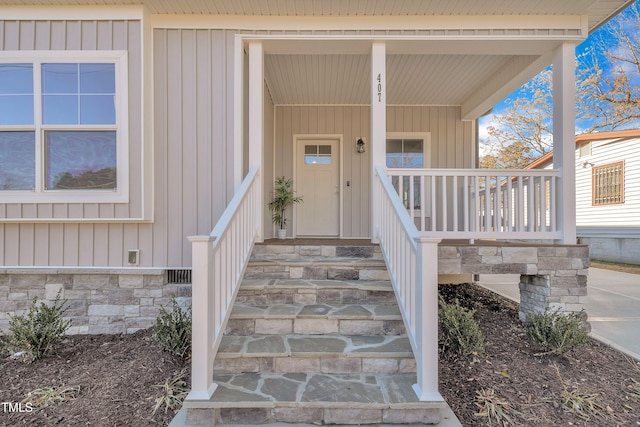 view of exterior entry with covered porch