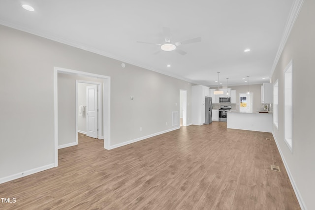 unfurnished living room with ceiling fan, ornamental molding, and light wood-type flooring