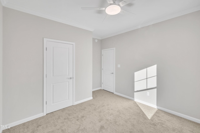 carpeted empty room with ceiling fan and ornamental molding