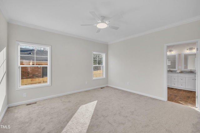 unfurnished bedroom with ceiling fan, connected bathroom, carpet, and crown molding