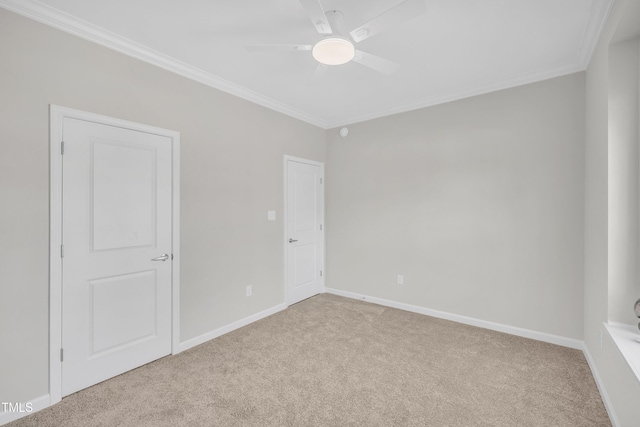 carpeted empty room with crown molding and ceiling fan