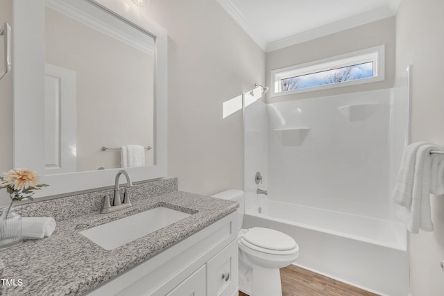 full bathroom with wood-type flooring, tub / shower combination, crown molding, toilet, and vanity