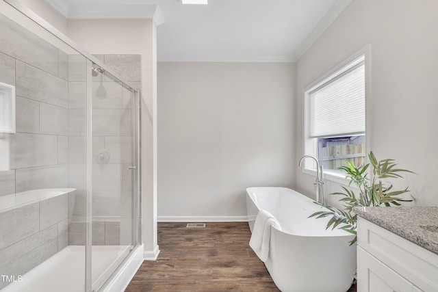 bathroom with vanity, hardwood / wood-style flooring, shower with separate bathtub, and ornamental molding